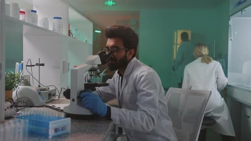Scientist Using Microscope in Modern Laboratory Setting