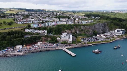 A High Angle Aerial Shot of a Coastal Town and Busy Marina