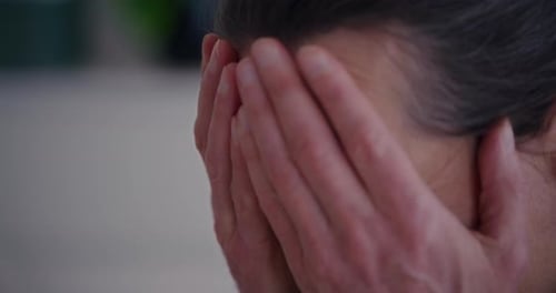 Stressed Senior Businessman Rubbing Face with Hands