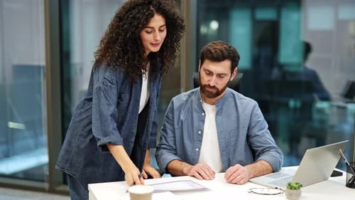Business Colleagues Discuss Project in Modern Office Woman and Man Working Together
