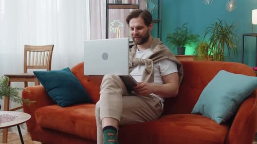 Man on Laptop Video Call at Home