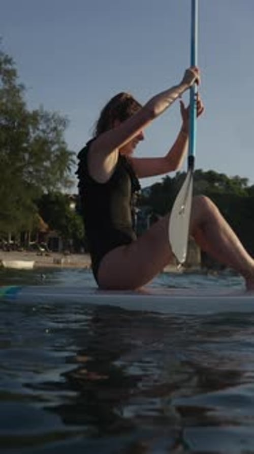 Woman Paddle Boarding on the Ocean