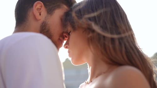 Close Up of Couple Embracing in Bright Sunlight