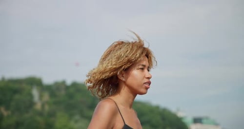 Young African American Woman Runner Jogging on City Bridge Outdoors