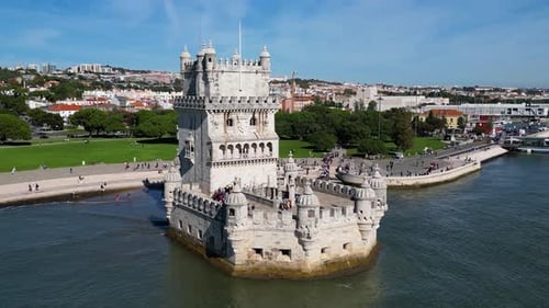 Aerial drone view of Belem Tower in Lisbon, Portugal during a beautiful sunny day next to the river