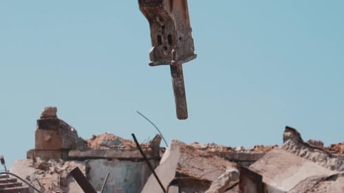 Hydraulic Hammer Moving Above Rubble During Demolition Work Close Up