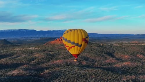 Hot Air Baloon Flying During Sunrise Over The Sedona, Arizona, USA. - aerial