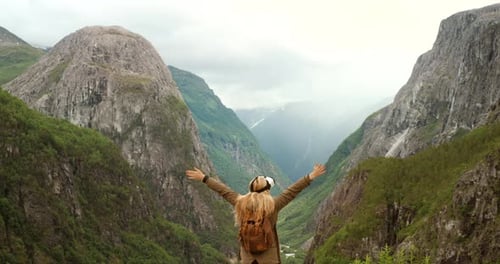 Woman Wearing VR Headset in Mountain Landscape