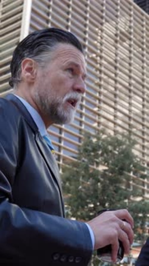 Two Professional Business Colleagues Talking to Each Other Standing Outdoors