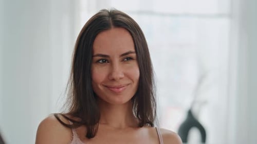 Smiling Woman with Long Hair Winks at Camera