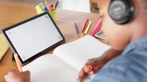 Child Writes Homework with Tablet Device