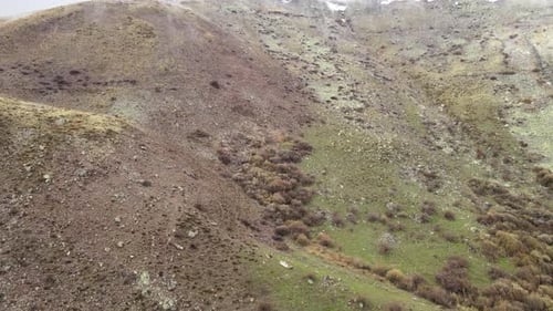 Drone View of Hilly Green and Rocky Landscape