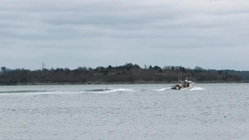 Boat With Passengers Sailing Across The Bay In Town Of Hull In Massachusetts - wide shot
