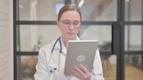Female Doctor Working on a Tablet in Office