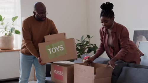 Black Woman Packing Family Belongings for Moving