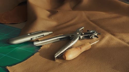 Leathercraft tools on a workbench - Artisan leather workshop
