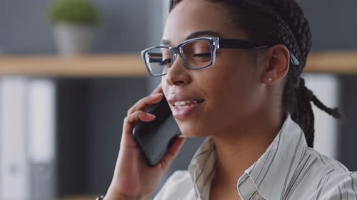 Smiling Woman Talking on Phone in Office Close Up