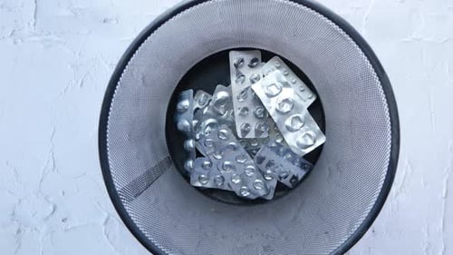 Top View of Pills and Blister Packs in a Bin