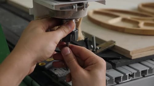 Hands Adjusting CNC Machine Tool Bit