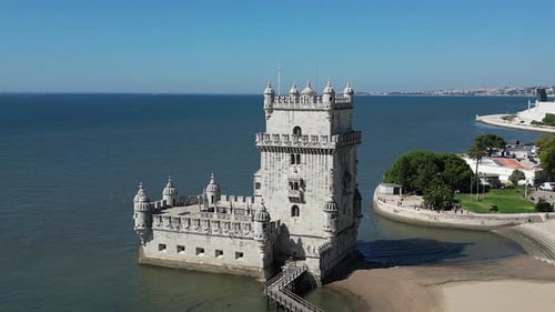 Aerial orbits carved stone Tower of Belem guarding Lisbon harbour