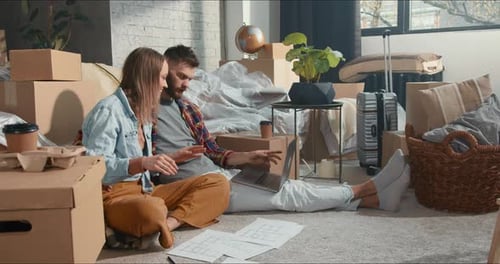 Couple Smiling with Laptop in New Home