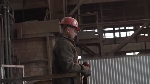 Factory Worker Resting in an Industrial Setting