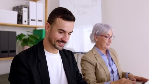 Diverse Business People Working Together on Laptop Computer in the Office