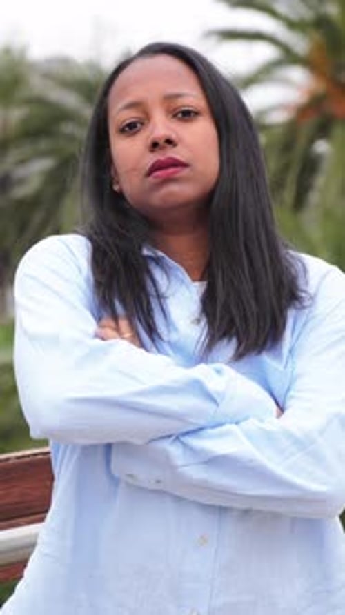Confident Young Woman Posing Outdoors in Urban Setting
