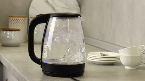 Kettle Boiling Water on Kitchen Counter in Home