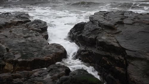 Crashing Waves Through Rocky Coastal Passage