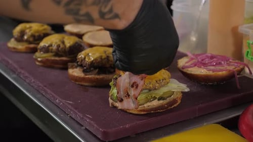 Chef Prepares Burgers in Restaurant Kitchen