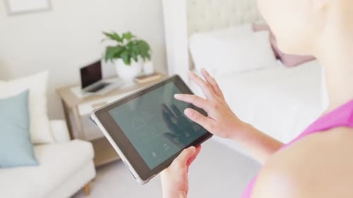 Woman Using Tablet for Smart Home Control