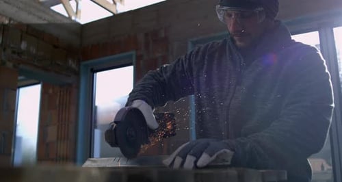 Man Grinds Metal with a Cut Off Wheel