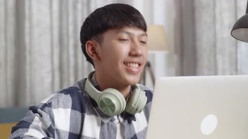Teen Smiles, Talks On Laptop In Home Setting