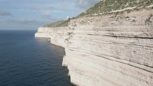 Drone footage over the sea at Malta island, next to a beatiful cliff