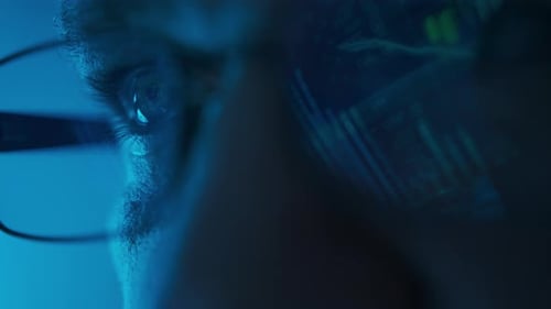 Stock Market Trader Working Investment Charts Graphs Ticker Diagrams Projected on Reflecting in