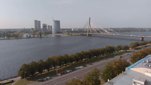 Drone aerial flying towards Vansu Bridge in Riga, Latvia on a clear day with no clouds