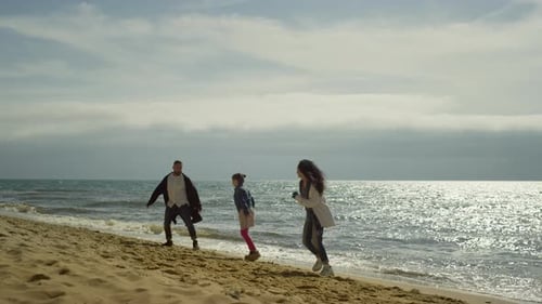 People Jumping Sea Beach Outside. Playful Family Enjoying Happy Holiday at Seaside