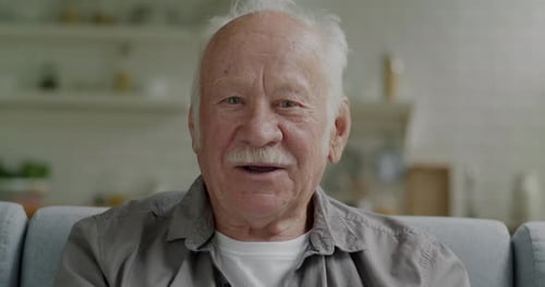 Senior Man Waving Hello Indoors