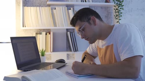 College student working on laptop.