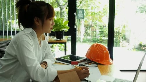 An architect or engineer working on blueprint, architectural concept.