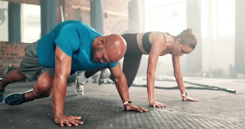 Couple, fitness and mountain climber exercise at gym on floor for workout or training together