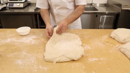 a chef makes bread in a bakery