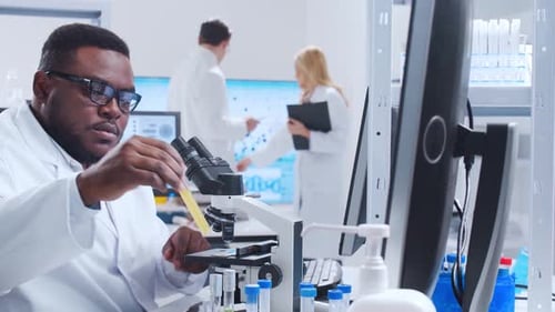 Scientist Working With Microscope in Modern Lab