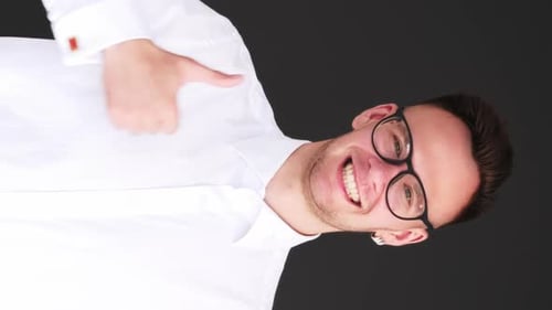 Cheerful Young Man Gives Thumbs Up Gesture