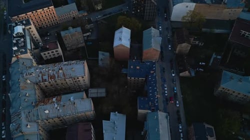 Aerial View of Urban Residential Area in Evening Light with Cityscape Streets Rooftops and Houses
