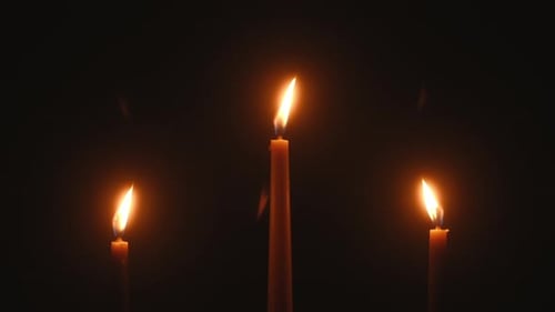 Glowing Candles Flicker in the Dark