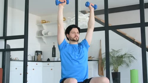 Man Exercising at Home Lifting Hand Weights