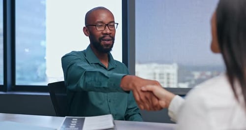 Business Handshake in Modern Office Setting
