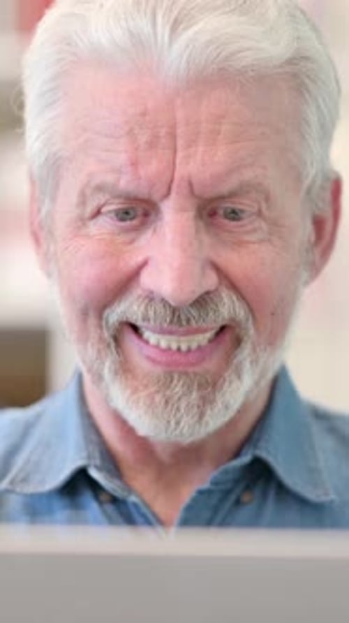 Close Up of Old Businessman Celebrating Success on Laptop, vertical video